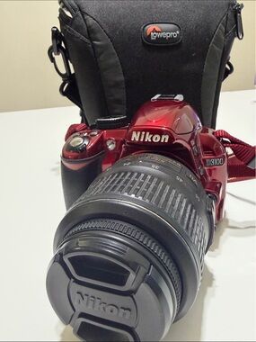 Nikon Red D3100 DSLR with Zoom Lens and Nikon Cap